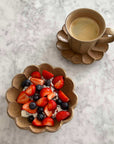 Flower-shaped Rinka Bowl 16cm with fresh fruit and matching mug, handcrafted porcelain from Kaneko Kohyo, Japan.