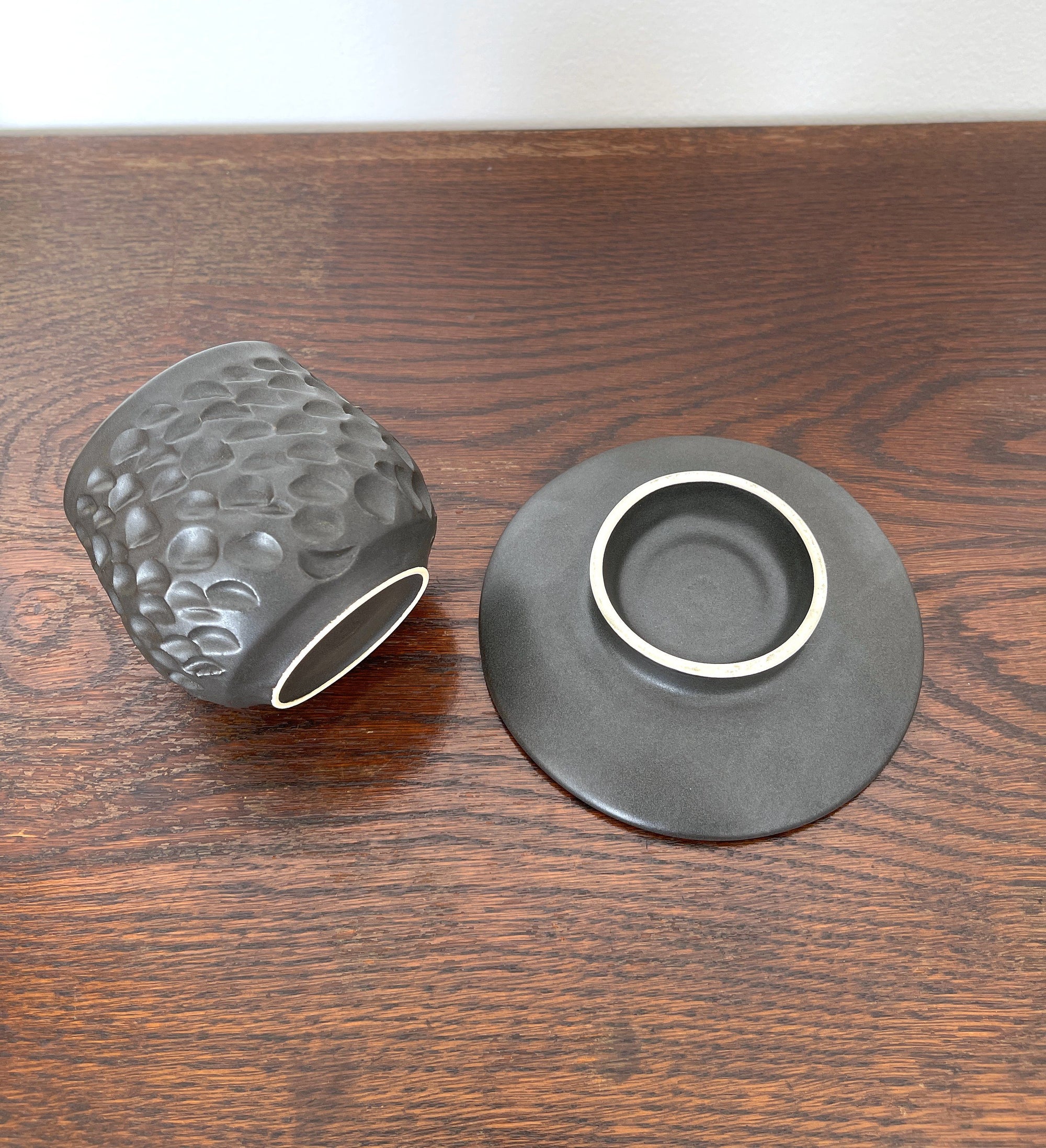 Shinogi Cup and Saucer Set with nature-inspired patterns by Yoshida Pottery, created by ceramist Masakazu Yoshida, on wooden table.