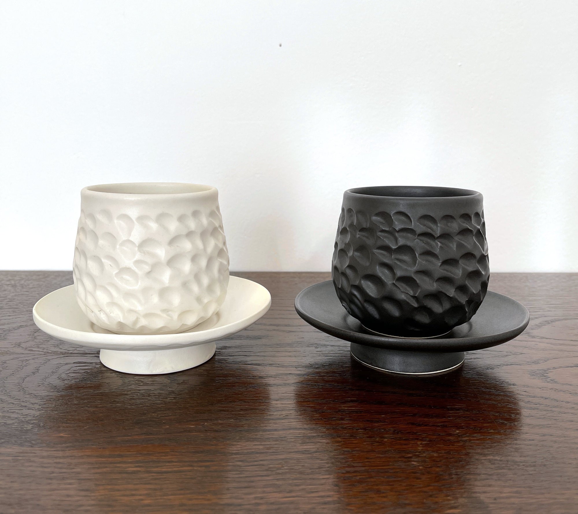Textured Shinogi Cup and Saucer Set in black and white, part of the Yoshida Pottery Collection, showcasing elegant nature-inspired design.