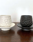Textured Shinogi Cup and Saucer Set in black and white, part of the Yoshida Pottery Collection, showcasing elegant nature-inspired design.