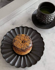 Elegant Rinka Plate by Yoshida Pottery with pastry and cup of green tea on a marble table setting.