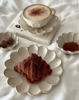 Elegant Rinka Bundle 4 dining set with a croissant on flower petal-shaped plates, showcasing Japanese-Western cultural blend.