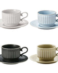 Four Storia Coffee Cup & Saucer sets in white, blue, black, and beige, showcasing antique European-inspired porcelain design.