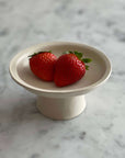 Elegant Yoshida Pottery tall plate with strawberries, nature-inspired design, adds sophistication to any table setting.