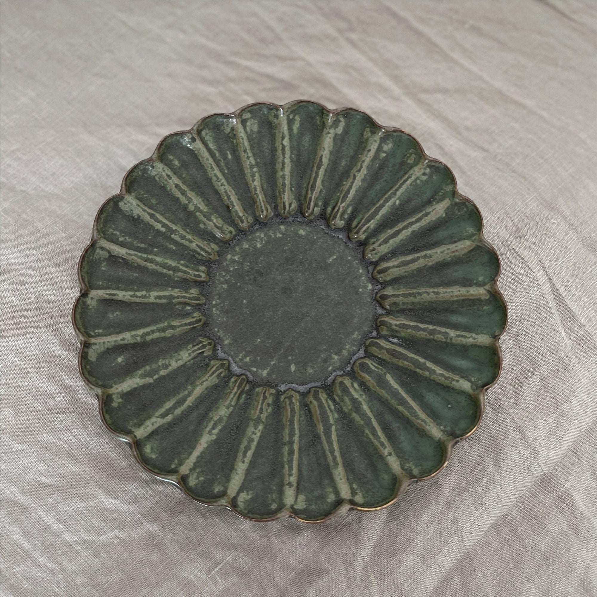 Elegant green Rinka Plate from Yoshida Pottery Collection showcasing nature-inspired patterns by ceramist Masakazu Yoshida.
