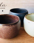 Three Rila Tea Cups in warm matte colors by Kaneko Kohyo, showcasing textured design and compact size for tea or desserts.