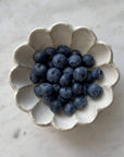 Porcelain Rinka Bowl 12cm with blueberries, Kaneko Kohyo handcrafted flower shape dish on marble surface