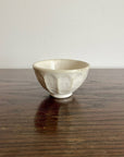 Handmade Rinka small soup bowl with unique glaze texture, 10.5cm, microwave and dishwasher safe, Japanese design on wooden table.