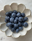 Handmade Rinka Bowl 12cm filled with fresh blueberries, showcasing its delicate flower-shaped porcelain design.