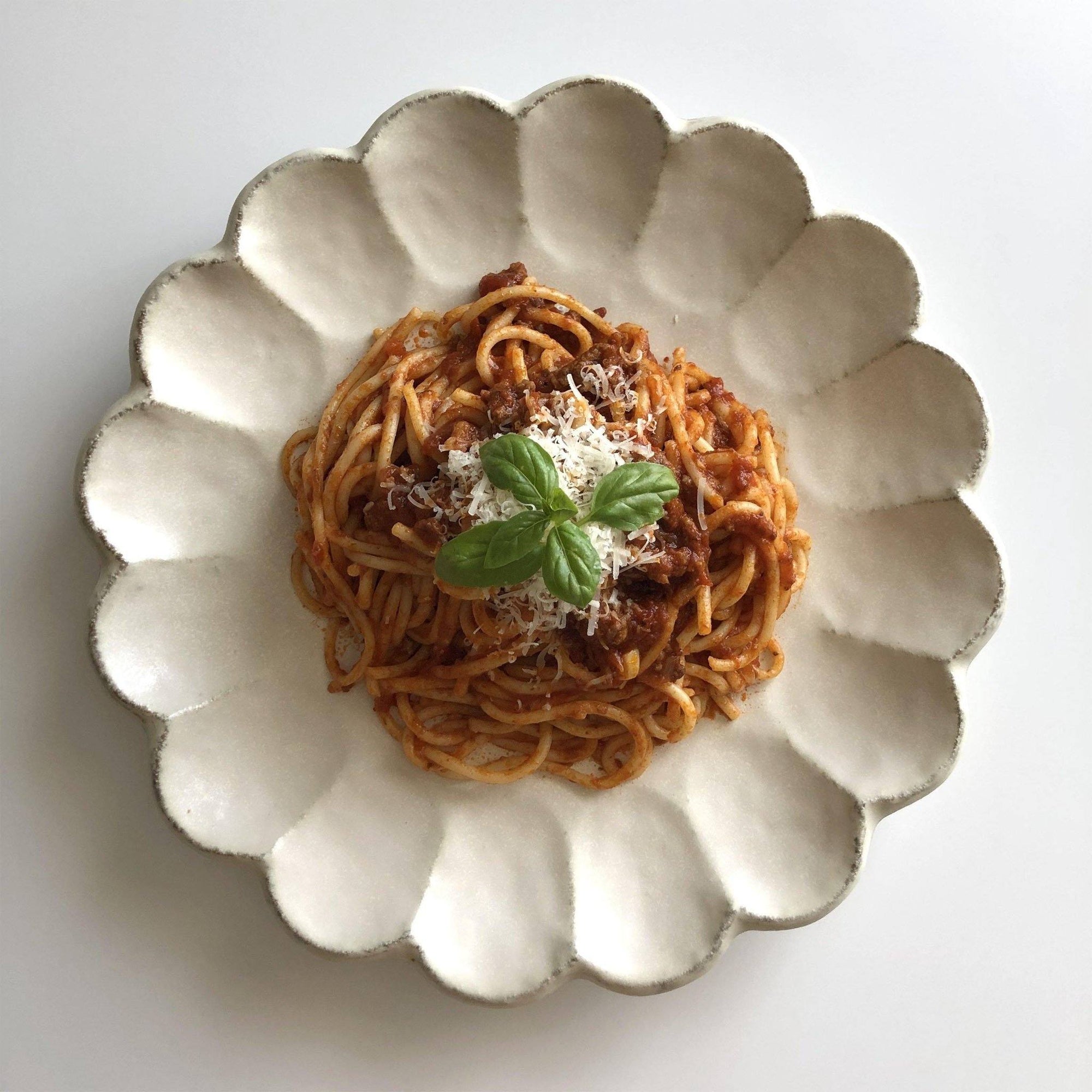 Elegant Rinka plate with spaghetti, showcasing Japanese porcelain craftsmanship and timeless design. Perfect for modern dining.