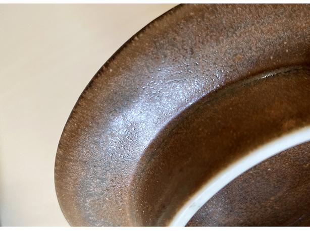 Close-up of Rila Brown plate by Kaneko Kohyo, featuring a textured matte finish, handcrafted porcelain, Japan. Microwave and dishwasher safe.