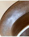 Close-up of Rila Brown plate by Kaneko Kohyo, featuring a textured matte finish, handcrafted porcelain, Japan. Microwave and dishwasher safe.