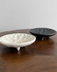 Mame Plate Elegant Black & Innocent White Set from Yoshida Pottery, showcasing nature-inspired design on a wooden table.