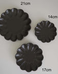 Three black Rinka plates by Kaneko Kohyo in sizes 21cm, 17cm, and 14cm, showcasing elegant handcrafted porcelain design.