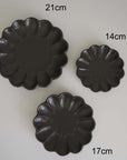 Three black Rinka plates by Kaneko Kohyo in sizes 21cm, 17cm, and 14cm, showcasing elegant handcrafted porcelain design.