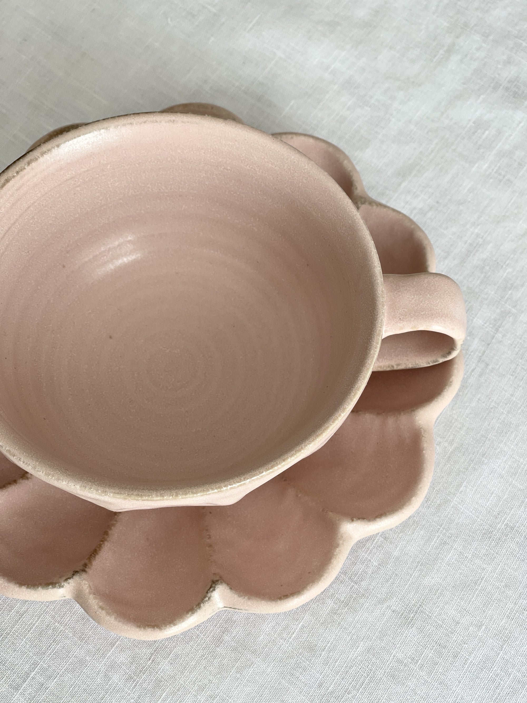 Delicate porcelain Rinka soup cup with flower shape, handcrafted by Kaneko Kohyo, matching saucer, Rinka Collection, pink hue.