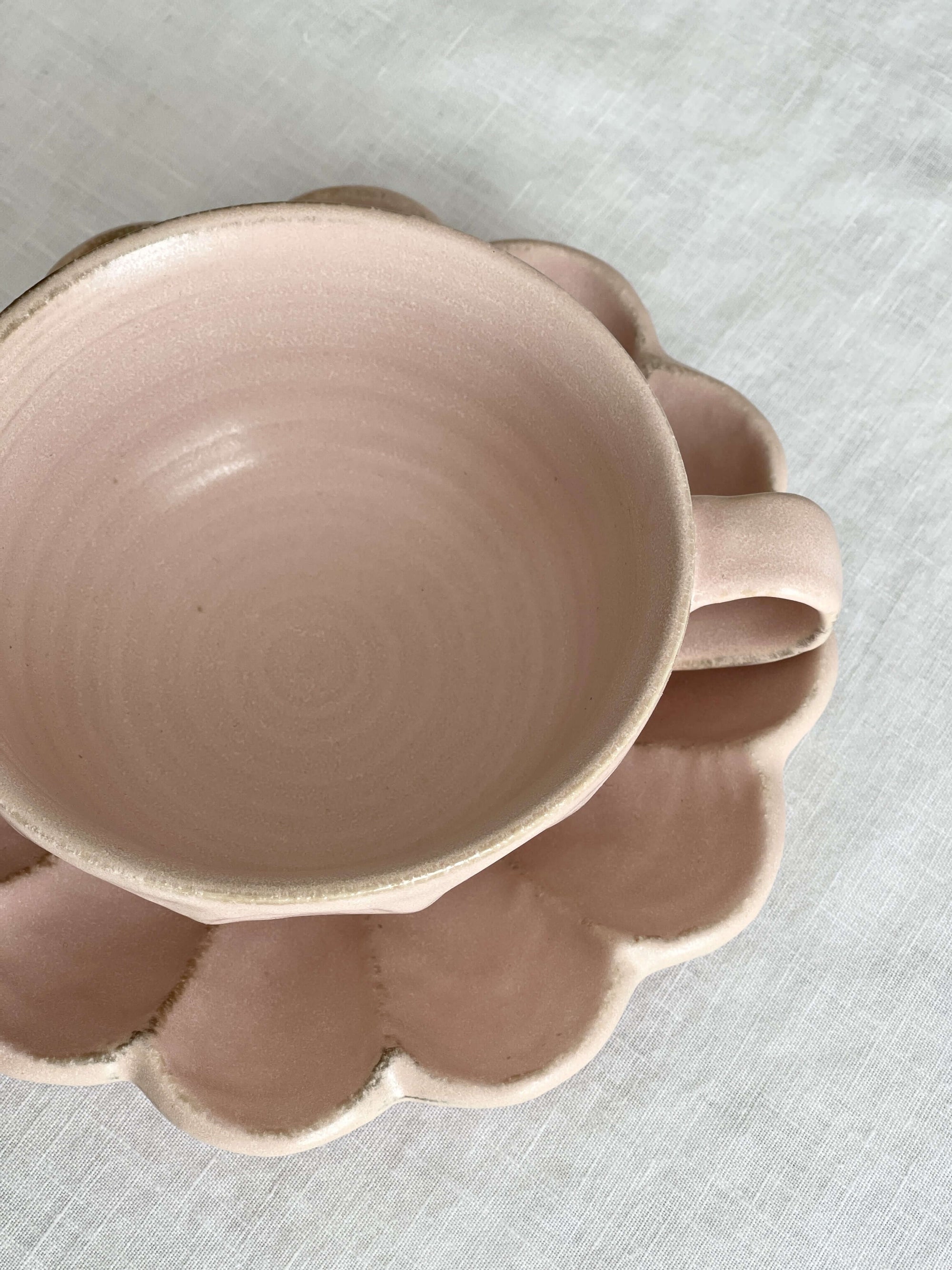 Pink porcelain Rinka soup cup with flower-shaped plate by Kaneko Kohyo, enhancing table aesthetics and culinary presentations.