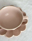 Pink porcelain Rinka soup cup with flower-shaped plate by Kaneko Kohyo, enhancing table aesthetics and culinary presentations.