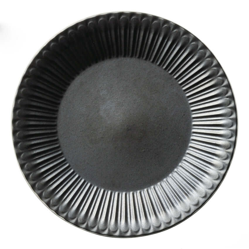 Black porcelain plate with textured edges, 20cm diameter, reminiscent of antique flatware from Japan. Dishwasher safe.
