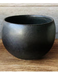Matte black Rila Tea Cup by Kaneko Kohyo, perfect for tea, desserts, or single-serve dishes, with a compact, stackable design.