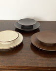 Rila 16cm porcelain plates by Kaneko Kohyo in warm matte colors, perfect with Rila Mugs, from Japan, set of three on wooden table.