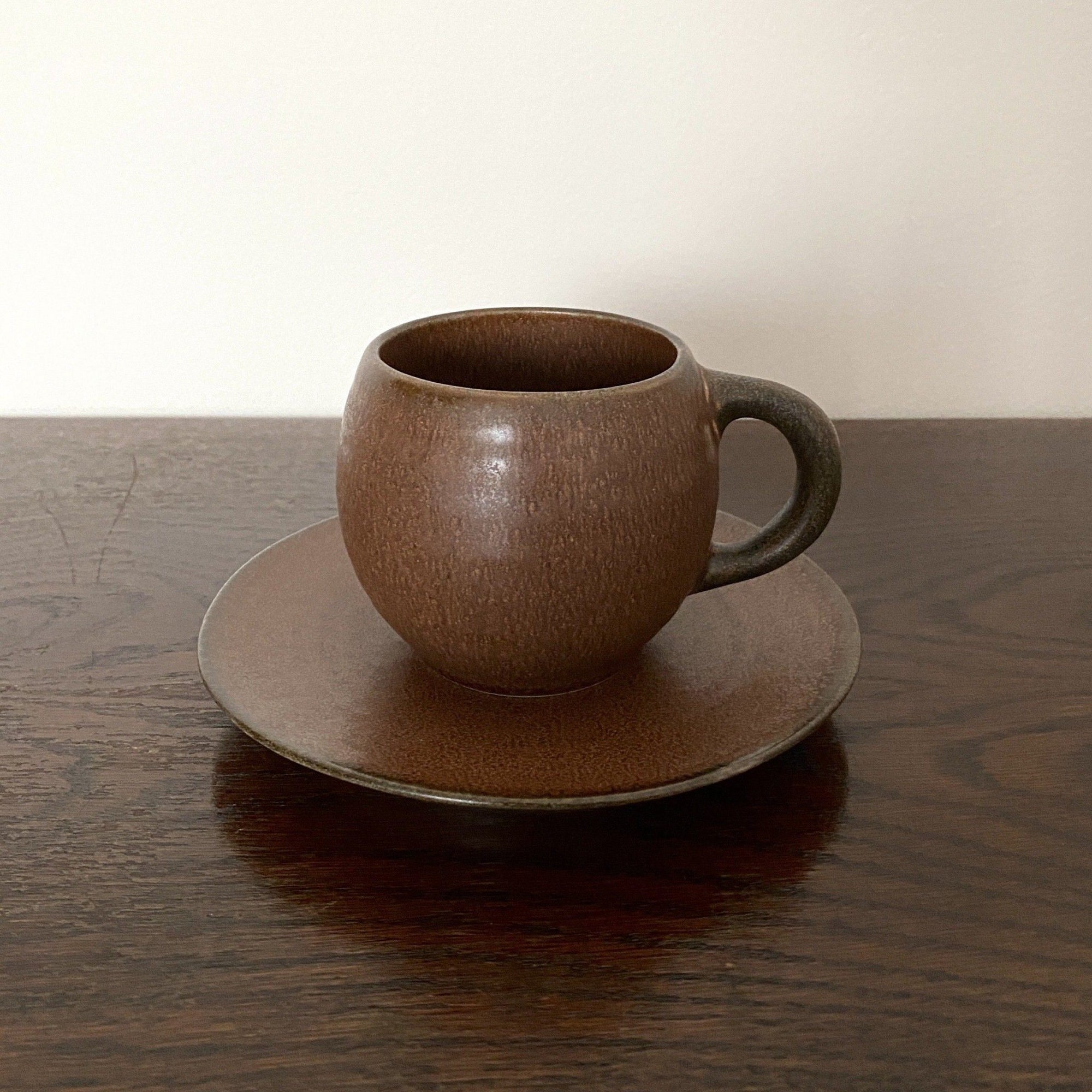 Rila Brown Mug with saucer by Kaneko Kohyo, showcasing its textured porcelain design and matte finish, perfect for microwave use.