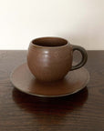 Rila Brown Mug with saucer by Kaneko Kohyo, showcasing its textured porcelain design and matte finish, perfect for microwave use.