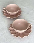 Two Rinka soup cups with flower-shaped saucers, handcrafted porcelain by Kaneko Kohyo, perfect for enhancing table settings.