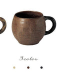 Three textured porcelain mugs in cream, brown, and black from Kaneko Kohyo factory, showcasing matte finish and ergonomic handles.