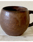 Rila Brown Mug with textured porcelain finish, warm matte color, microwave-safe, crafted by Kaneko Kohyo, perfect palm size.