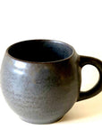 Rila Black Mug with handle, made of textured porcelain from Kaneko Kohyo, featuring a matte finish and microwave-safe design.