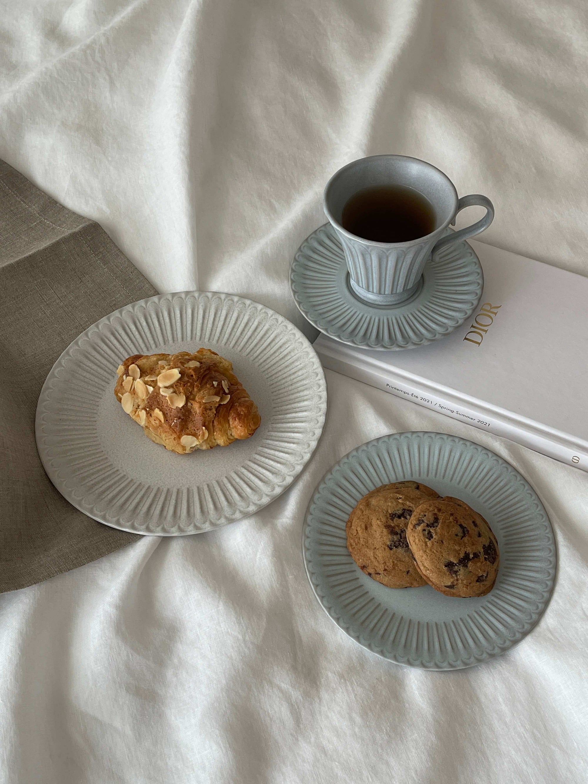 Elegant table setting with pastries and tea on Storia plates, showcasing nostalgic and romantic porcelain tableware.