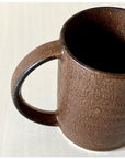 Rila Brown Straight Mug with textured porcelain finish from Kaneko Kohyo Factory, Japan, shown on a light surface.