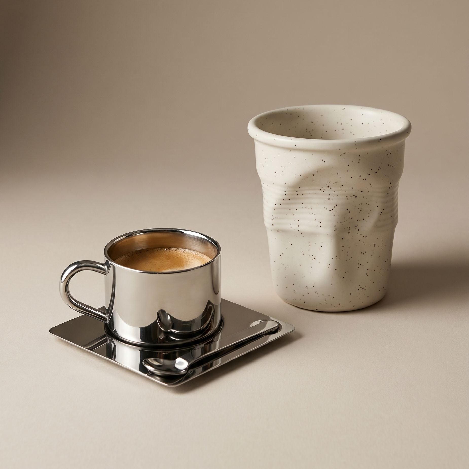 Stainless steel coffee cups from LoveÉcru styled on a tray