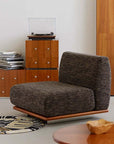 Modern Nozomi Banca Sofa with gray upholstery in a stylish living room setting featuring wooden cabinets and a turntable.