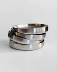 Noir Steel Plates fanned in a stack, showing the raised rim