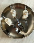 Shoreline Cutlery Set laid on a round steel plate