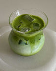 Sora Glass with an iced matcha latte on a marble surface