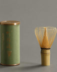 Artisan Bamboo Matcha Whisk in natural bamboo beside the storage tube