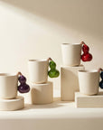 The four Fruit Handle Ceramic Mug colorways together