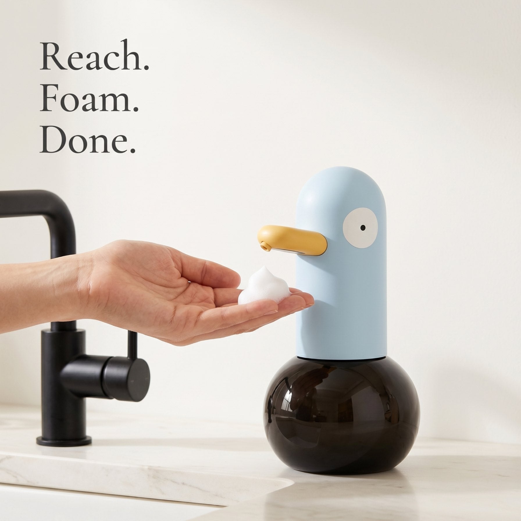 Butter cream duck-shaped automatic foam soap dispenser on a marble bathroom vanity — LoveÉcru" (vary per image: side profile, both colours, foam close-up, refill, in use).