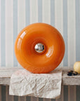 Orange Halo Touch Lamp on a stack of paper