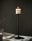 Tall 30 cm Retro Iron Candlestick with a lit pillar candle in a dark room
