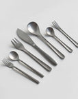 Kyoto Cutlery Set, seven pieces in matte brushed stainless steel laid out flat