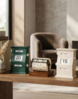 Vintage Perpetual Desk Calendars on a wooden desk beside a lamp