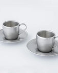 Vintage Inox stainless steel cup and saucer set from Japan, dishwasher safe, shown on a white background.