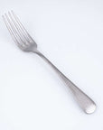 Vintage Inox Old English dinner fork with a smooth handle design, ideal for luxurious dining and versatile use in formal settings.