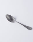 Vintage Inox Baguette Classic Series stainless steel spoon with elegant handle design on white background.