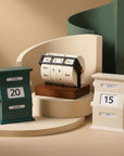 Vintage Perpetual Desk Calendars, green block, wheel and cream block, against a green wall