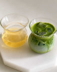 Two Sora Glasses, one with tea and one with iced matcha